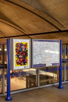 A poster of the 33rd pocket Tube map cover by Phyllida Barlow is seen in a station.