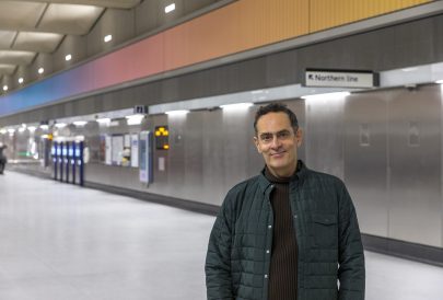 Artist Alexandre da Cunha stands in front of his 60 metre long kinetic sculpture which runs the length of the ticket hall at Battersea Power Station Underground station